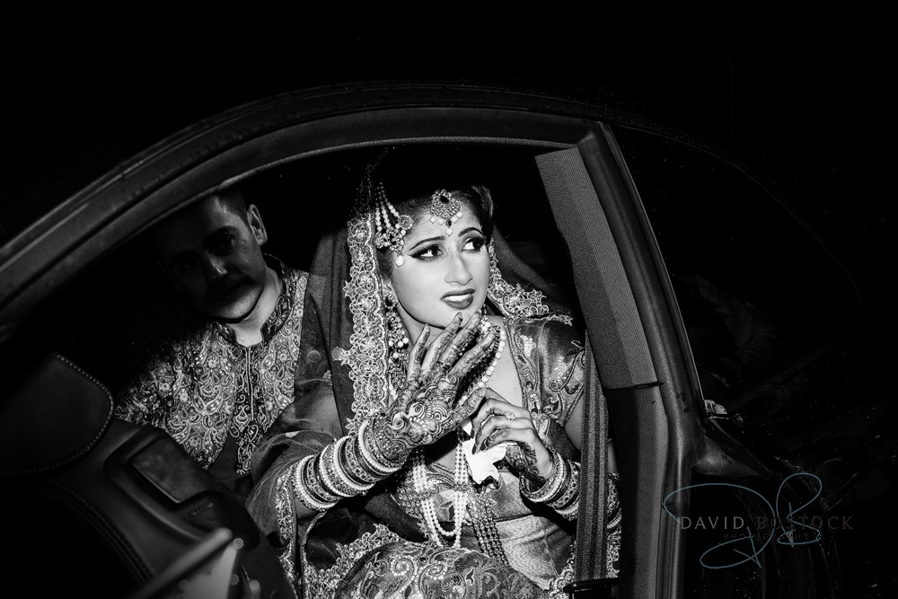 Indian bride in car saying farewell to her family